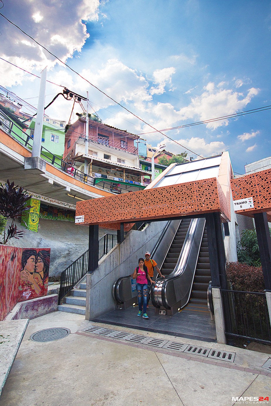 colombian teens taking escalator in comuna 13 in medellin colombia