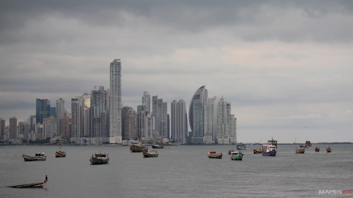 fishing boats in panama city harbor against cityscape