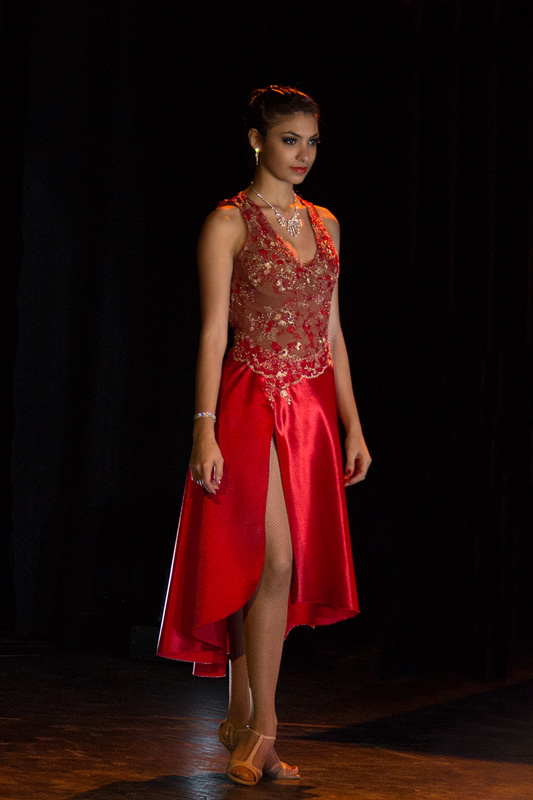 female tango dancer in red dress preparing for competition
