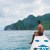 Filipino guide sitting on bow of boat during tour in El Nido
