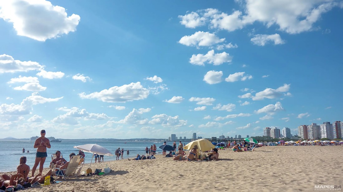beachgoers relaxing at playa mansa, uruguay