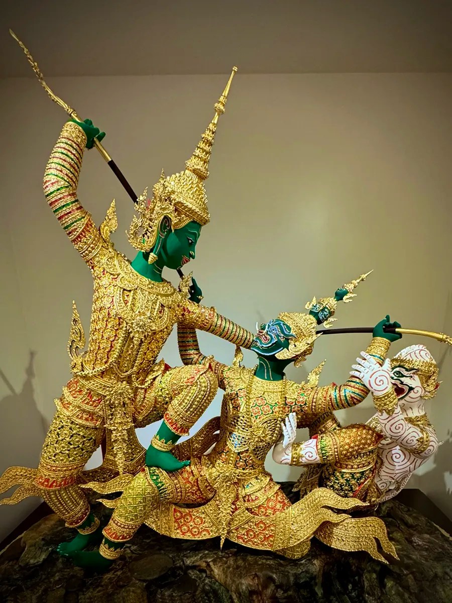 a gold and green sculpture of Ramakien which depicts a battle between prince Rama and the demon king Tosakanth