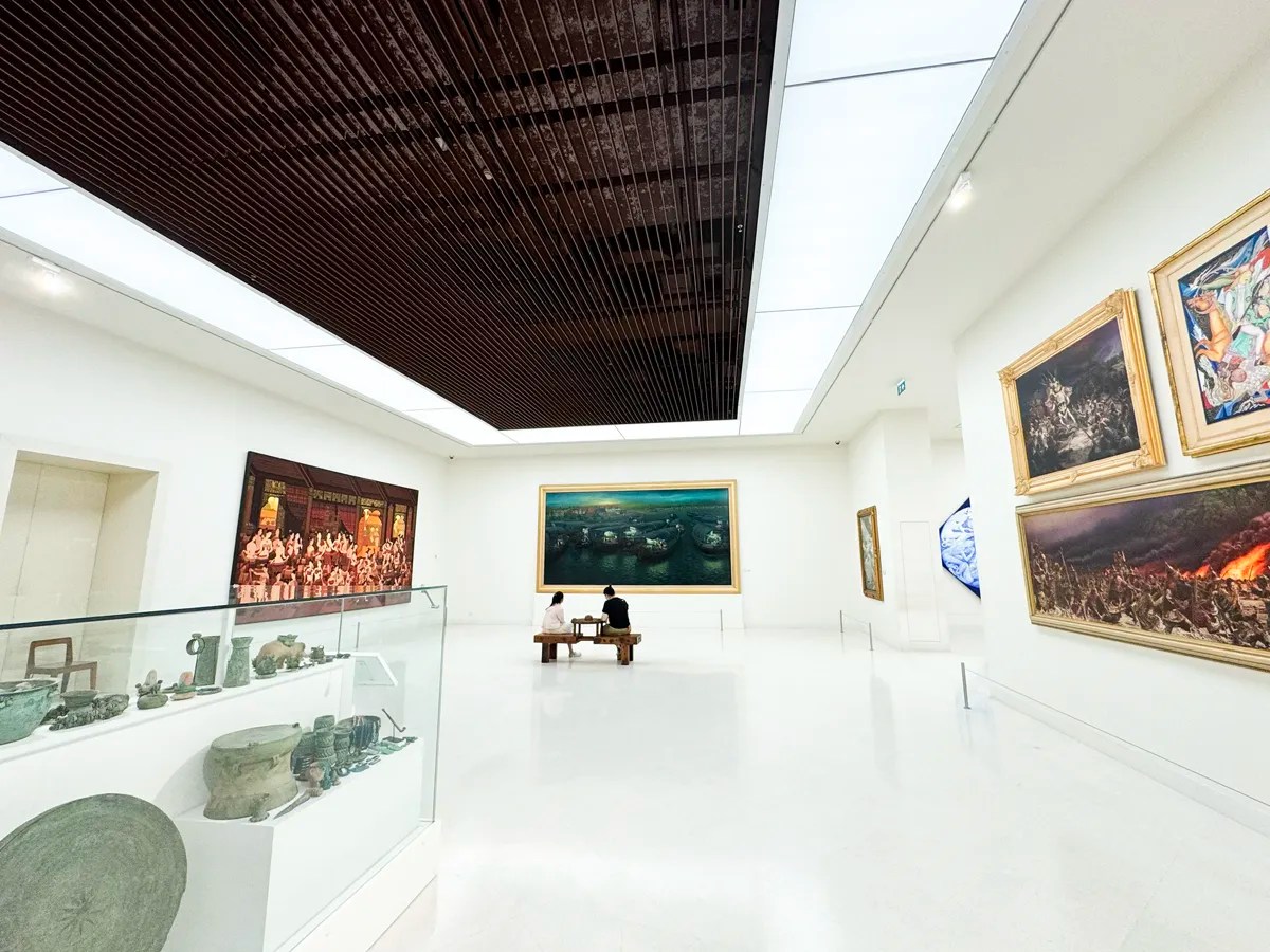 A couple resting on a bench while appreciating beautiful art at the MOCA Bangkok