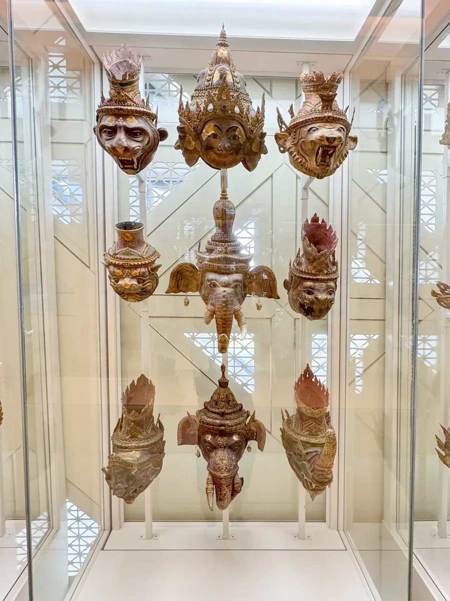 a display of wooden khon masks in different shapes, such as rhino, elephant, tiger and man